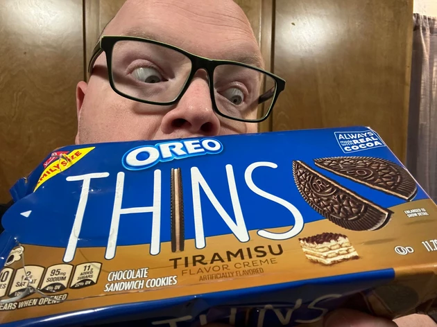 bald guy with glasses holding package of cookies