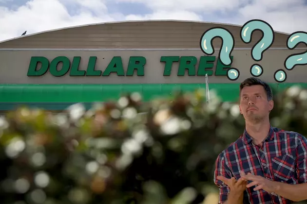 man counting his fingers looking up with question marks in front of a dollar tree.