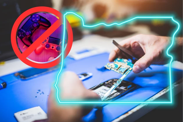 man fixing circuit board of a phone. Circle Slash around video game controllers